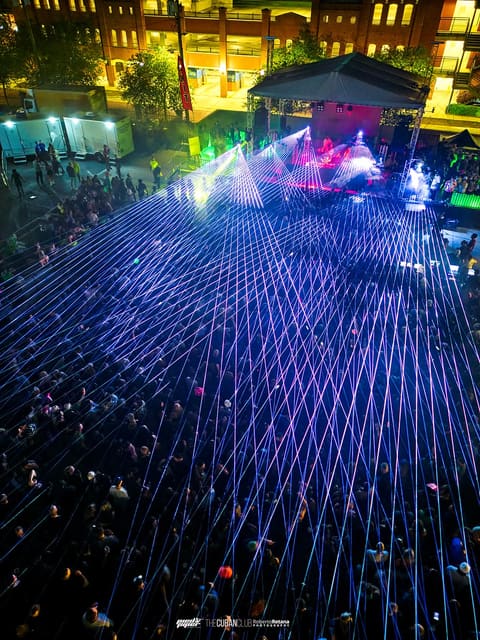 Aerial view of a laser grid fanning over the packed crowd at Dom Dolla's show at The Cuban Club, Ybor City, 2023