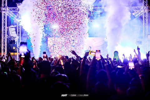 Confetti and CO2 cannons erupt over a crowd with phones raised during Two Friends at The Cuban Club, Ybor City, 2025