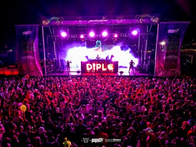 Purple lights and smoke over a packed crowd during Diplo's set on the main stage, Pied Piper's Haunted Carnival 2023